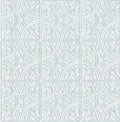 The Ashley Stark Home Willa Tile Peel and Stick Wallpaper by WallPops showcases an ornate, embossed white and light gray tile pattern with symmetrical floral and leaf motifs encircled within each tile. This uniformly repeating design creates a textured, elegant, and vintage look across any surface.