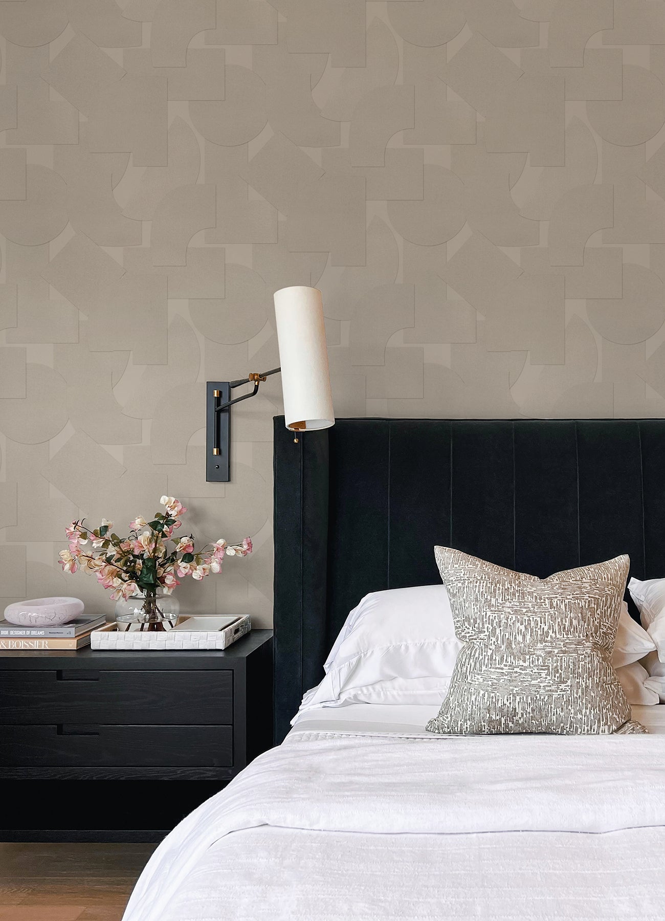 Featuring a pattern of overlapping black geometric shapes—rectangles, semicircles, and squares—set against a dark background, the Ashley Stark Home Bas Geometric Peel and Stick Wallpaper by WallPops creates a subtly textured effect with its nearly indistinguishable monochromatic design.