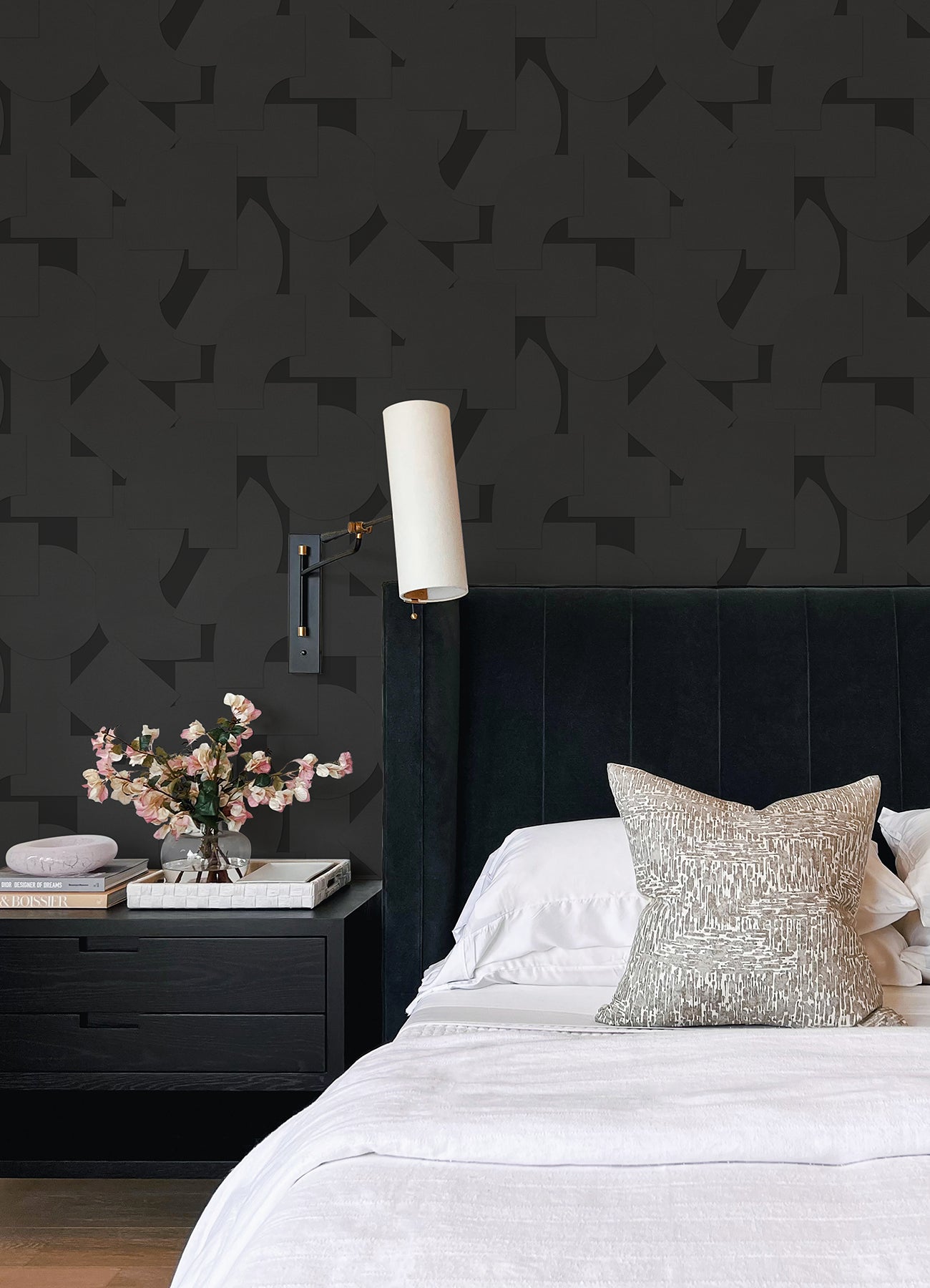 Featuring a pattern of overlapping black geometric shapes—rectangles, semicircles, and squares—set against a dark background, the Ashley Stark Home Bas Geometric Peel and Stick Wallpaper by WallPops creates a subtly textured effect with its nearly indistinguishable monochromatic design.