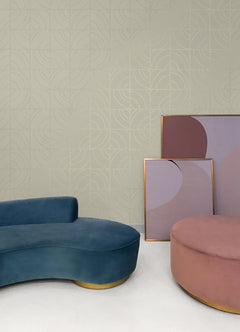 A person’s hands peel back a corner of WallPops Egypt Sherrod Batik Blok Peel and Stick Wallpaper, featuring abstract curved lines on a beige background, revealing its adhesive backing. The wallpaper rests on a wooden surface, and the person wears a ring on their left hand.