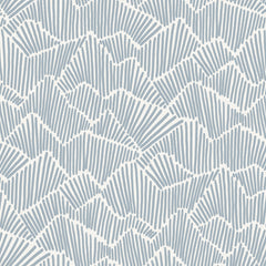 Two hands peel back a sheet of WallPops Egypt Sherrod Ridge & Valley Peel and Stick Wallpaper, which features a white abstract geometric line pattern on a beige background. The wallpaper is partially lifted from a wooden surface, and the person’s left hand is adorned with a ring.