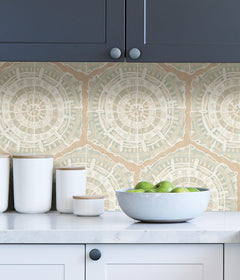 A modern dining room featuring a wooden table, eight black chairs, white built-in cabinets, and blue LiLi WhittWhitt Harmony Peel and Stick Wallpaper by WallPops. Above a white fireplace hangs a colorful abstract portrait. The space is accented with decorative pottery, candles, and a single-stem vase.