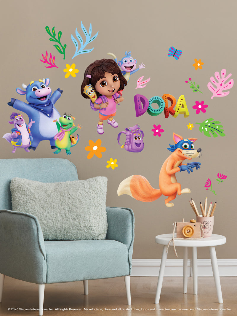Colorful Dora the Explorer wall decals above a white chair and table with pencils. Dora, Boots, Swiper, Backpack, Map, and animal friends appear among leaves and flowers on a beige wall. DORA is spelled out in bright, multicolored letters.