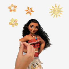 Maui, Moana, a rooster, tiny coconut pirates, and a pig stand in a row on a white background as delightful Disney characters. Maui appears tall and muscular, Moana wears her signature red skirt, the rooster is blue and yellow, and the pig is small and white. With their dimensions illustrated beside them, these WallPops Disney Moana Characters Wall Decals offer a charming rustic look—perfect for decorating your space with easy-to-apply peel and stick wall art.