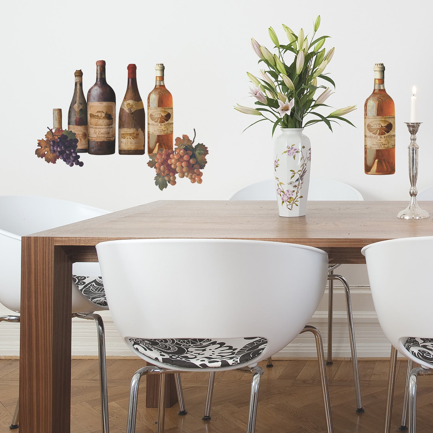 WallPops Wine Tasting Wall Decals package comes with 56 charming peel and stick decals featuring a delightful wine and kitchen motif. The sample image shows bottles, jars, and glasses arranged artfully on a kitchen counter, making them a perfect match for rustic interiors. These easy-to-apply wall decals are visible through the packaging window, offering an ideal way to bring countryside charm to your space.