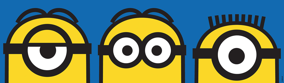 A person wearing a silver ring on their hand peels the backing off a large sticker resembling the WallPops Universal Studios Minions Always Eyeconic Border. The sticker features part of a cartoon character with yellow skin, round eyes, and black goggles set against a blue and yellow background, all laid out on a wooden surface.