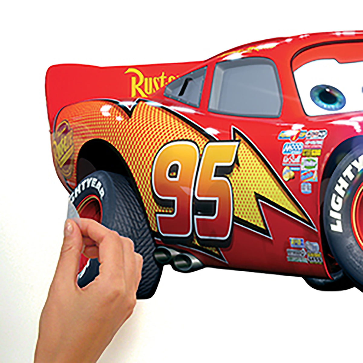 WallPops Cars - Lightening Mcqueen Peel & Stick Giant Wall Decal featuring a red race car with a friendly expression, blue eyes, number 95, a lightning bolt, and sponsor logos in a rustic design.
