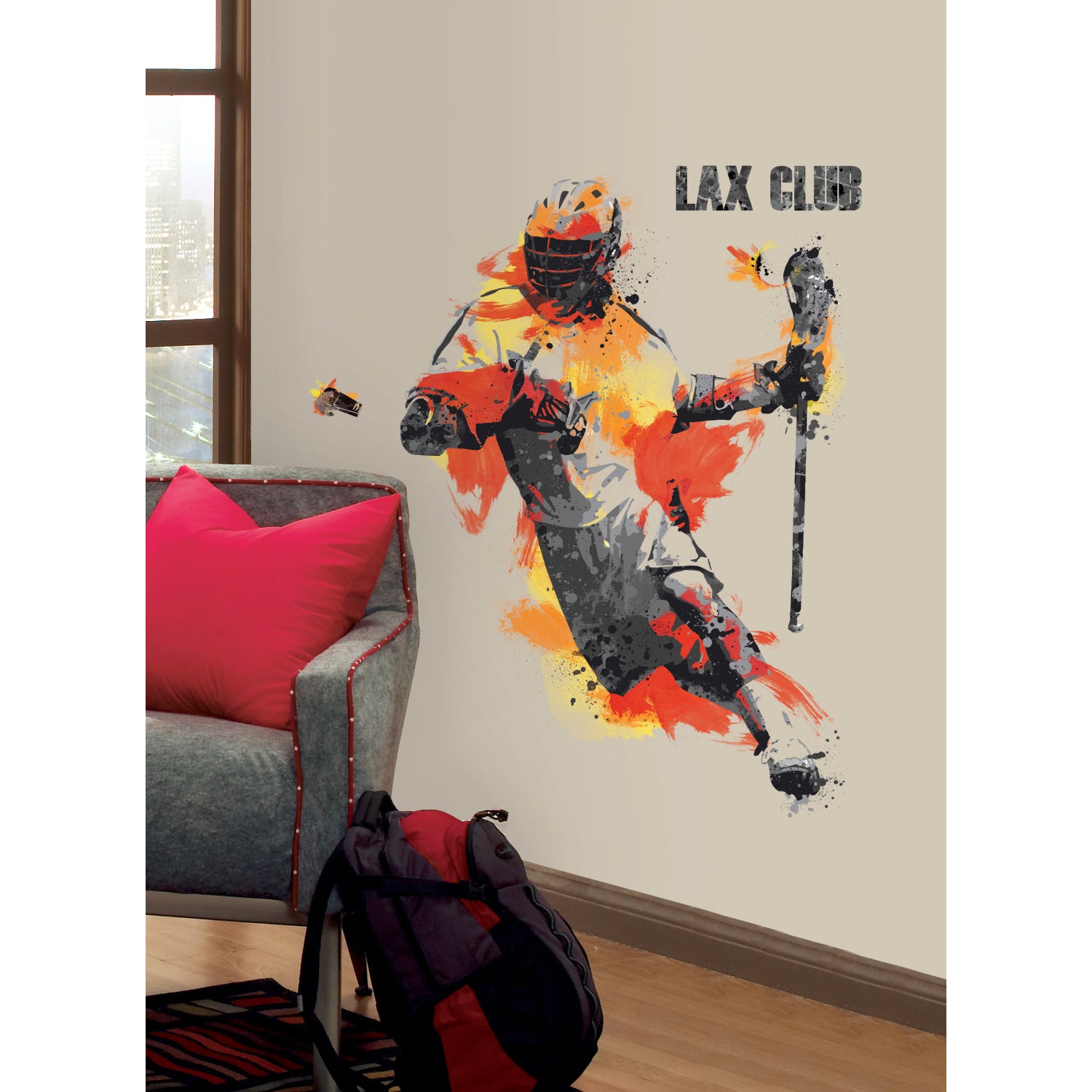 Introducing the Mens Lacrosse Champion Giant Wall Decals by WallPops—a peel and stick wall decal featuring a lacrosse player in dynamic action, rendered in orange, yellow, and gray hues with a helmet and stick. The bold LAX CLUB text appears beside the athlete, infusing your space with sporty energy. Effortlessly update your decor while complementing rustic elements like distressed barn wood textures. Styled here with a gray chair accented by red pillows for a coordinated look.