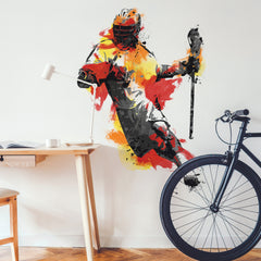 Introducing the Mens Lacrosse Champion Giant Wall Decals by WallPops—a peel and stick wall decal featuring a lacrosse player in dynamic action, rendered in orange, yellow, and gray hues with a helmet and stick. The bold LAX CLUB text appears beside the athlete, infusing your space with sporty energy. Effortlessly update your decor while complementing rustic elements like distressed barn wood textures. Styled here with a gray chair accented by red pillows for a coordinated look.