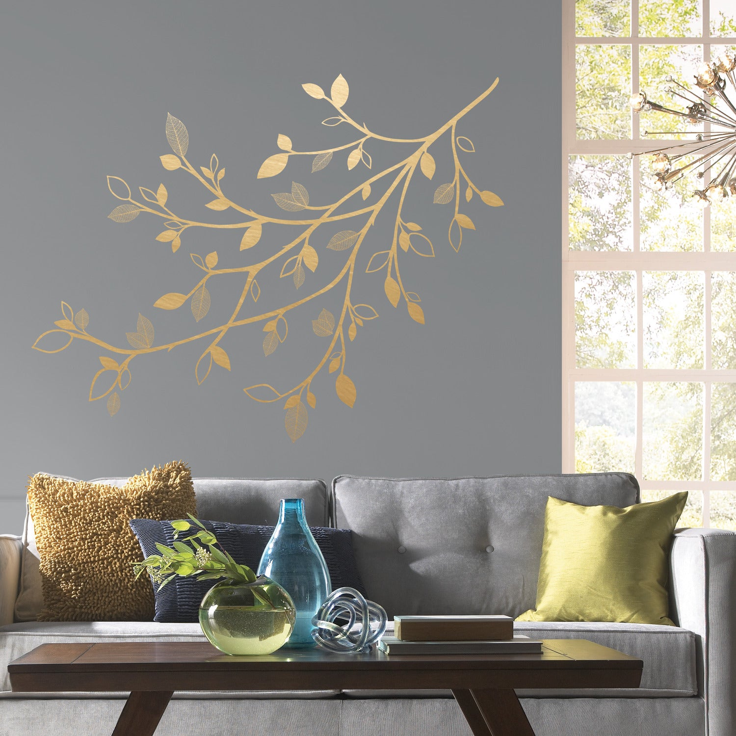 The WallPops Gold Branch Peel and Stick Giant Wall Decals with 3D Leaves feature a delicate gold branch with multiple slender stems and assorted leaf sizes, some showcasing detailed vein patterns for added texture and elegance. Displayed on a white background, this simple botanical design is ideal for enhancing rustic interiors or pairing beautifully with distressed barn wood accents.
