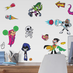 Brighten any space with WallPops Teen Titans GO! Peel and Stick Wall Decals featuring Raven, Beast Boy, Robin, Starfire, and Cyborg surrounded by cartoon objects—sharks, pizza, tentacles, boom boxes, flames, and stars—scattered on a white background.