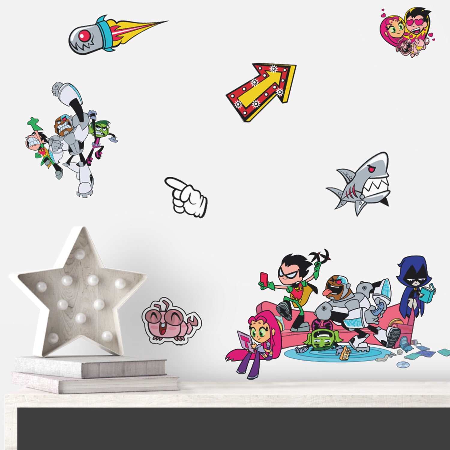 Brighten any space with WallPops Teen Titans GO! Peel and Stick Wall Decals featuring Raven, Beast Boy, Robin, Starfire, and Cyborg surrounded by cartoon objects—sharks, pizza, tentacles, boom boxes, flames, and stars—scattered on a white background.