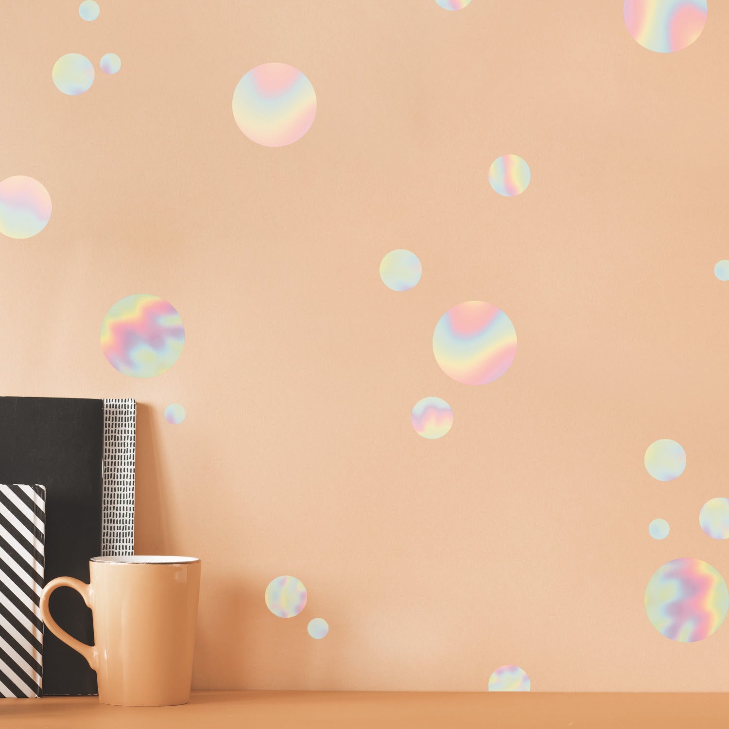 A white background dotted with an array of holographic circles in various sizes, each displaying a pastel rainbow shimmer reminiscent of soap bubbles. These spaced-apart decals feature soft gradients of pink, blue, yellow, and green, creating a light and airy pattern. The Holographic Circle Peel and Stick Wall Decals by WallPops offer a whimsical accent that complements both modern and rustic décor styles—perfect for transforming any space effortlessly.