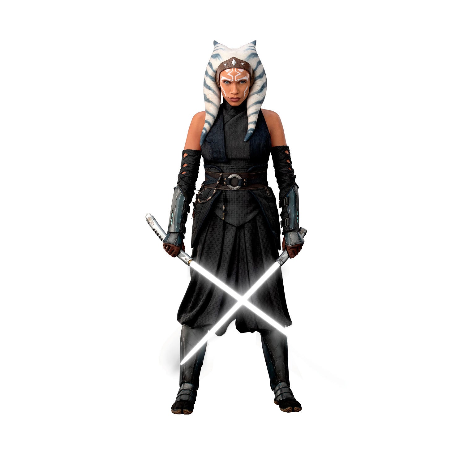A striking silhouette of Ahsoka Tano, clad in black armor with blue and white striped head-tails and facial markings, stands confidently holding two crossed white lightsabers—her arms wrapped in dark gauntlets—against a plain white background. The Star Wars Ahsoka Peel and Stick Giant Wall Decal by WallPops is an inspiring way to add bold character to any room.