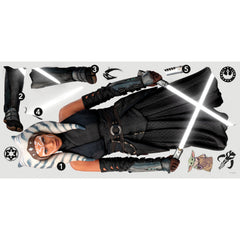 A striking silhouette of Ahsoka Tano, clad in black armor with blue and white striped head-tails and facial markings, stands confidently holding two crossed white lightsabers—her arms wrapped in dark gauntlets—against a plain white background. The Star Wars Ahsoka Peel and Stick Giant Wall Decal by WallPops is an inspiring way to add bold character to any room.