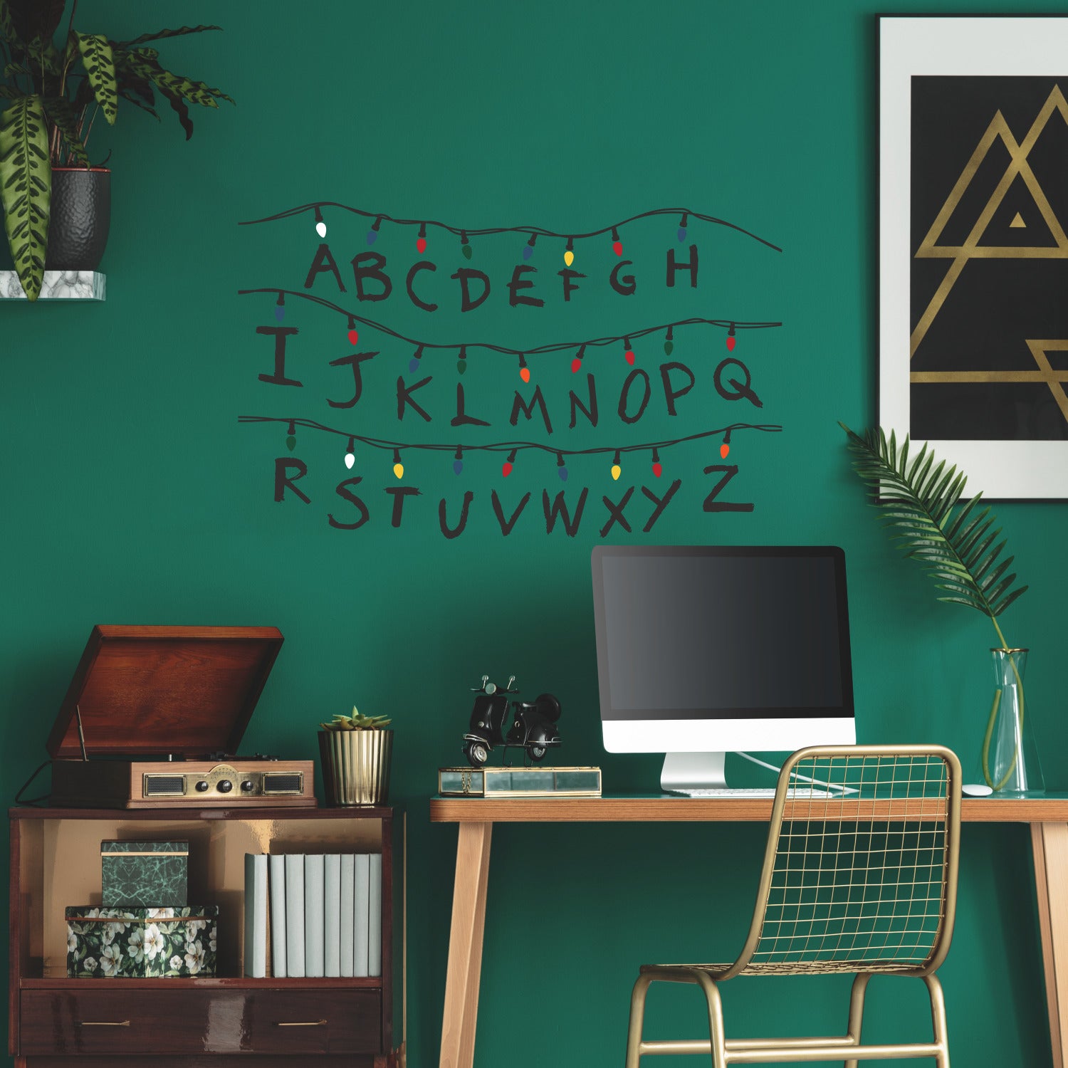 The WallPops Netflix Stranger Things Christmas Lights Peel And Stick Giant Wall Decals With Alphabet features a hand-drawn alphabet arranged in three rows, each row displayed beneath a line of colorful Christmas lights and accented with circled numbers 1–8 along the lines. This rustic design, measuring 27.43 69.6 cm tall by 46.04 1.16 m wide, boasts a light gray background reminiscent of distressed barn wood for added character.