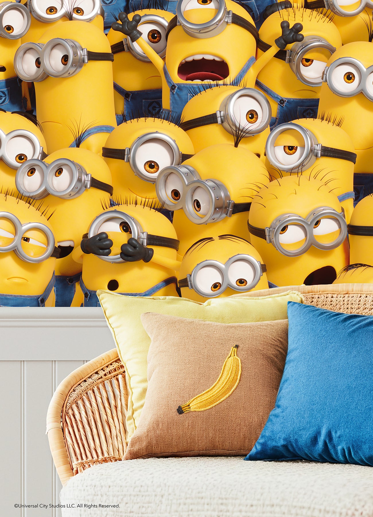 A lively scene from the Universal Studios Minions One in a Minion Peel and Stick Mural by WallPops shows a crowd of small yellow Minions—complete with goggles, blue overalls, and unique expressions—gathered closely together. Some are grinning, others appear surprised or are calling out, all adding to the playful and chaotic energy of this mural.