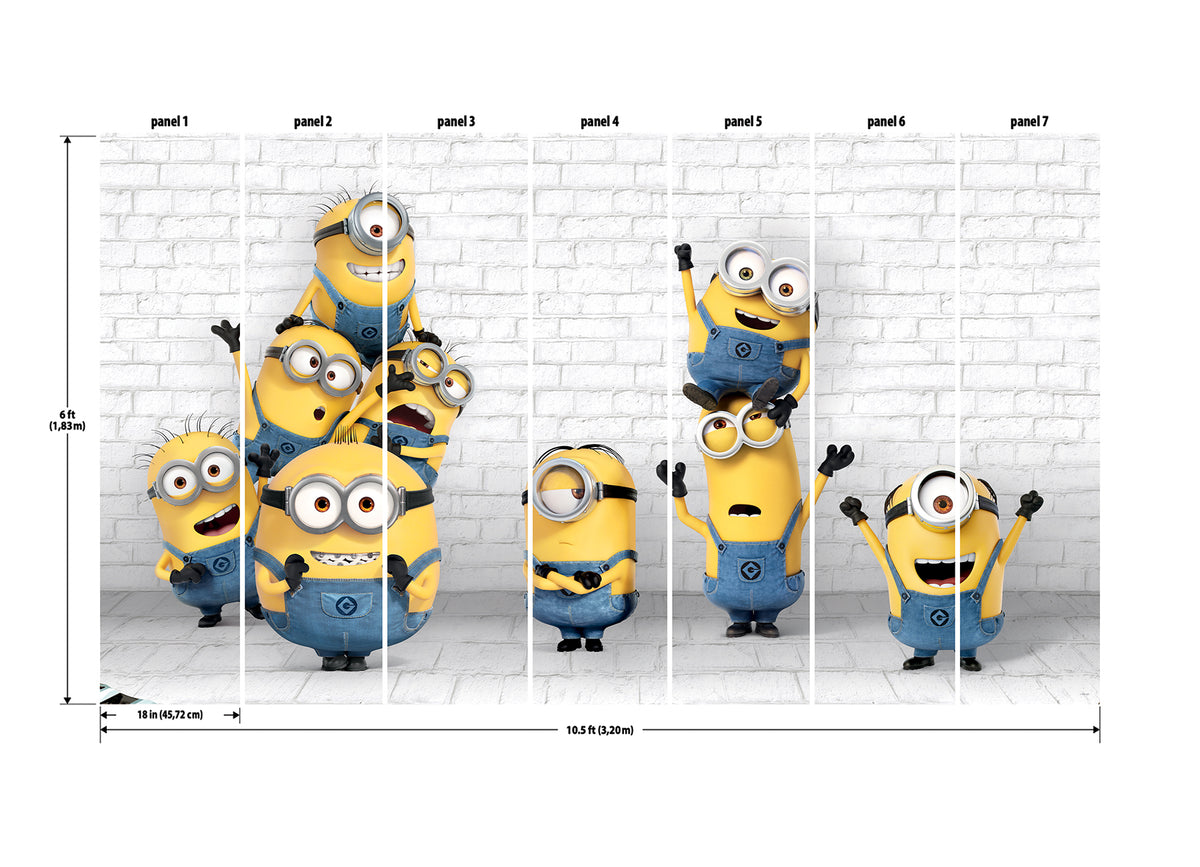 Eight Minions in blue overalls, with their signature yellow bodies and goggles, stand and stack joyfully against a white brick wall in the WallPops Minions Making Mischief Peel and Stick Mural. Some raise their arms in excitement, one perches playfully on top of another, and all display cheerful expressions.