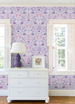 WallPops Frozen II Frozen Castle Damask Peel and Stick Wallpaper features pastel pink and lavender castle motifs with floral patterns, stylized flowers, leaves, hearts, and face profiles. Removable. Dimensions: 18 ft x 20.5 in.