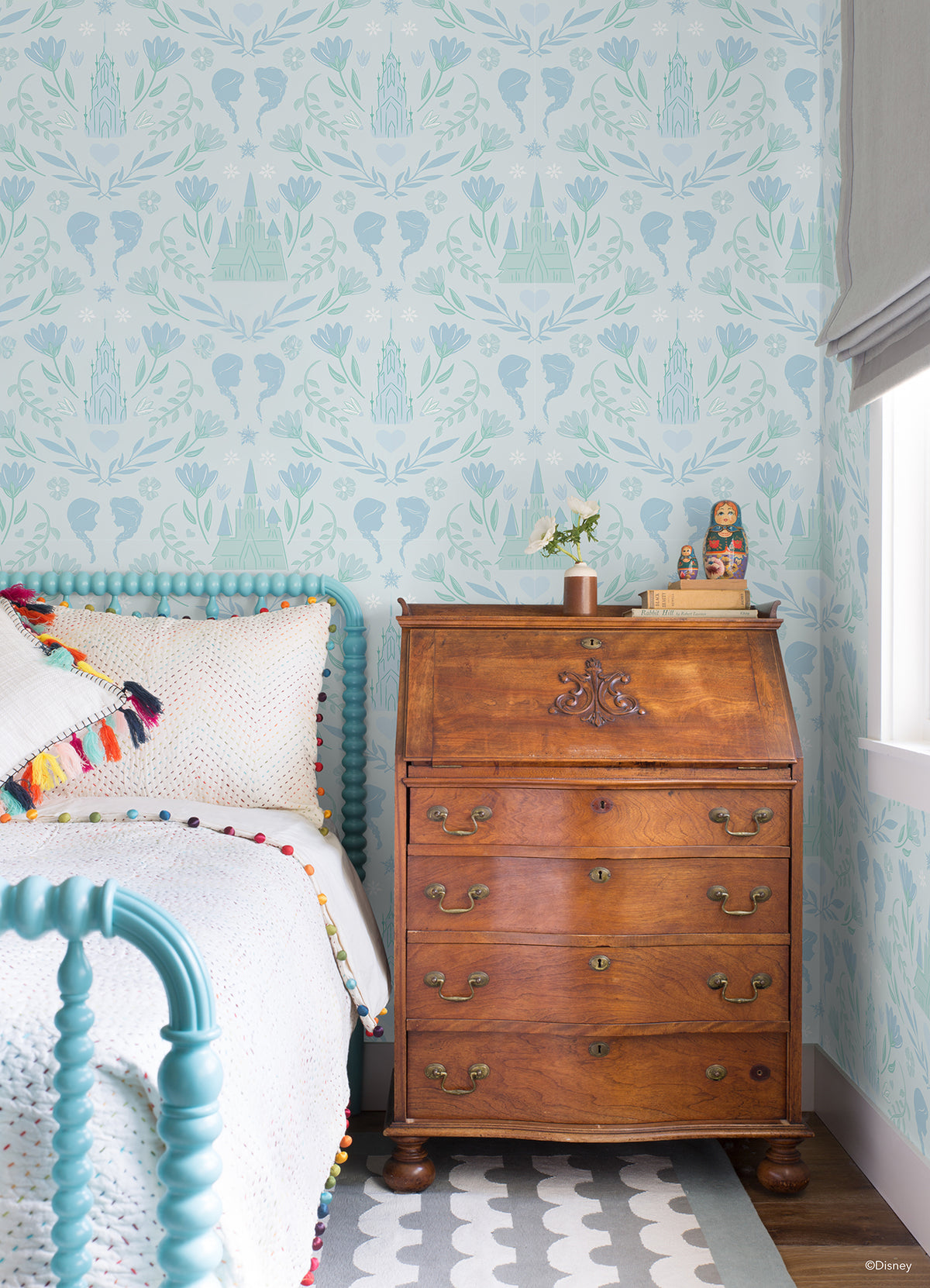 WallPops Frozen II Frozen Castle Damask Peel and Stick Wallpaper features pastel pink and lavender castle motifs with floral patterns, stylized flowers, leaves, hearts, and face profiles. Removable. Dimensions: 18 ft x 20.5 in.