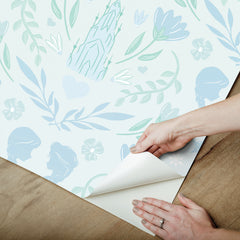 WallPops Frozen II Frozen Castle Damask Peel and Stick Wallpaper features pastel pink and lavender castle motifs with floral patterns, stylized flowers, leaves, hearts, and face profiles. Removable. Dimensions: 18 ft x 20.5 in.