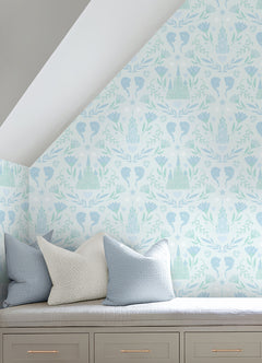 WallPops Frozen II Frozen Castle Damask Peel and Stick Wallpaper features pastel pink and lavender castle motifs with floral patterns, stylized flowers, leaves, hearts, and face profiles. Removable. Dimensions: 18 ft x 20.5 in.