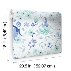 Hands with a silver ring smooth Frozen II Frozen 2 Anna and Elsa Floral Peel and Stick Wallpaper by WallPops onto a cream wall, aligning its repeating pink floral pattern and cartoon girls in blue dresses.