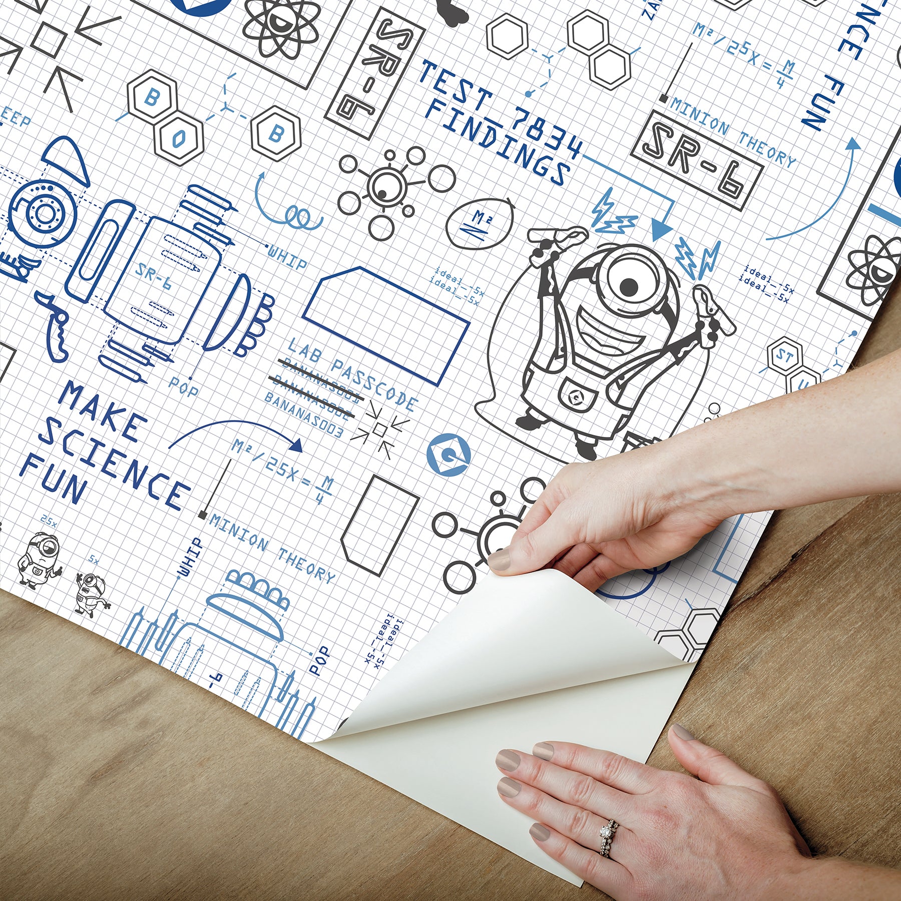 Featuring playful black line illustrations of Minions in lab coats, chemistry equipment, lab tools, QR codes, scientific diagrams, and phrases such as “MAKE SCIENCE FUN,” “TEST 7834 FINDINGS,” “SR-6,” and “LAB PASSCODE: BANANA3005” on a patterned white background with subtle watercolor stripe effects throughout. The Universal Studios Minions Science In Progress Peel and Stick Wallpaper by WallPops is perfect for adding a fun, scientific touch to any space.