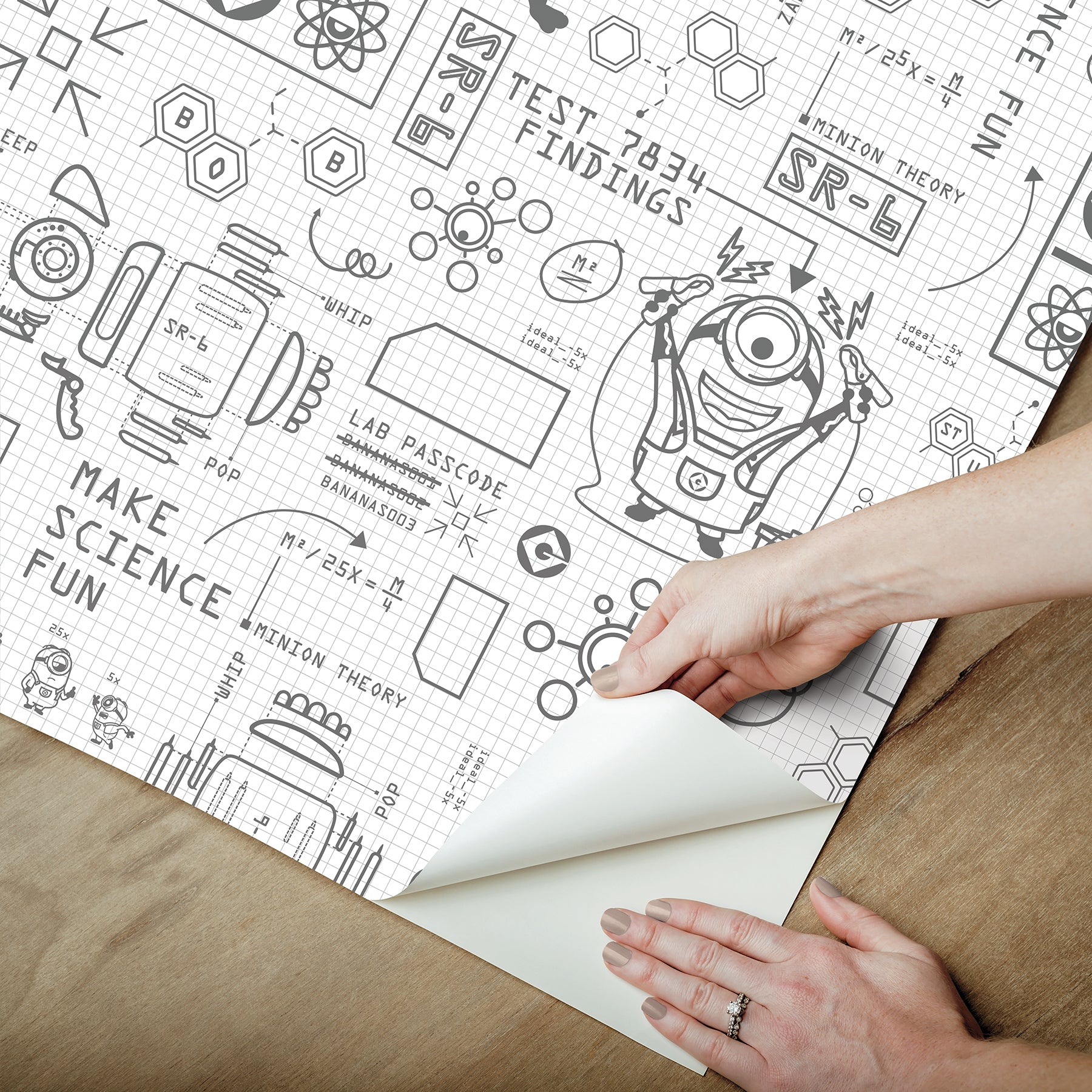 Featuring playful black line illustrations of Minions in lab coats, chemistry equipment, lab tools, QR codes, scientific diagrams, and phrases such as “MAKE SCIENCE FUN,” “TEST 7834 FINDINGS,” “SR-6,” and “LAB PASSCODE: BANANA3005” on a patterned white background with subtle watercolor stripe effects throughout. The Universal Studios Minions Science In Progress Peel and Stick Wallpaper by WallPops is perfect for adding a fun, scientific touch to any space.