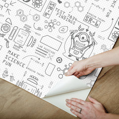 Featuring playful black line illustrations of Minions in lab coats, chemistry equipment, lab tools, QR codes, scientific diagrams, and phrases such as “MAKE SCIENCE FUN,” “TEST 7834 FINDINGS,” “SR-6,” and “LAB PASSCODE: BANANA3005” on a patterned white background with subtle watercolor stripe effects throughout. The Universal Studios Minions Science In Progress Peel and Stick Wallpaper by WallPops is perfect for adding a fun, scientific touch to any space.