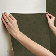 A close-up view of a cork board surface reveals a natural, subtly uneven texture composed of tiny light to medium brown granules pressed together. This organic look would beautifully complement WallPops’ RuPaul RuSuede Peel and Stick Wallpaper or pair seamlessly with other azure blue wallcoverings for easy and stylish customization. The surface is shown free from any objects, pins, or text.
