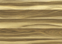 A black coffee cup rests on a surface covered with WallPops Modern Wood Adhesive Film in a light brown color, next to an open notebook with a pen and a small green plant placed on its page; the lower portion of the image displays empty table space showcasing the stylish film.