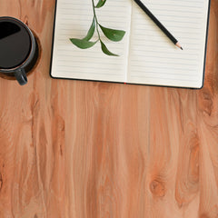 The Light Walnut Adhesive Film from WallPops features a smooth, light-colored wood surface with subtle, flowing grain patterns and gentle natural swirls. Its consistent texture displays varying shades of beige and pale brown, providing an elegant wooden finish with no visible objects—just the authentic look of wood grain.